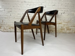 Pair of chairs made in Denmark and designed by Kai Kristiansen 1960s. One small split in one of the seats $700/pair