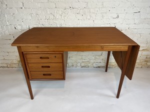 Gorgeous high quality Danish teak drop-leaf desk by Erik Buch for Oddense Maskinsnedkeri AS, - Denmark - double sided - 3 drawers in front that are comprised of soldi teak fronts - WOW and there is a display shelf on the other side - it also is brilliantly designed with a drop leaf that can be extended if more space is needed - newly refinished - SOLD