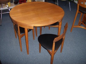 A Mid-century Marvel - one of the greatest designs to come out of Denmark - Designed by Hans Olsen 1952 /manufactured by Frem Rojle - Teak dining table and 4 -3 legged chairs that nest right into the skirt of the table - perfect for small spaces - Nice overall condition - 2 of the 3 legged chair seats have small splits - Super price - (SOLD)